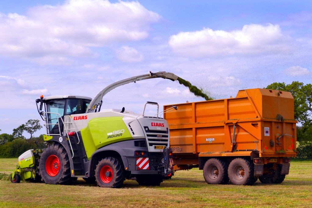 Machinery cutting grass for silage